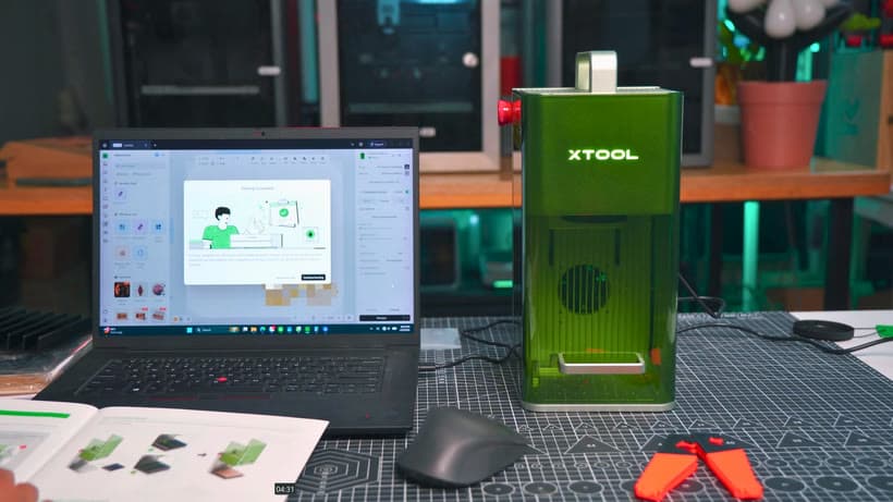 xTool laser engraver next to a laptop while filming a tutorial